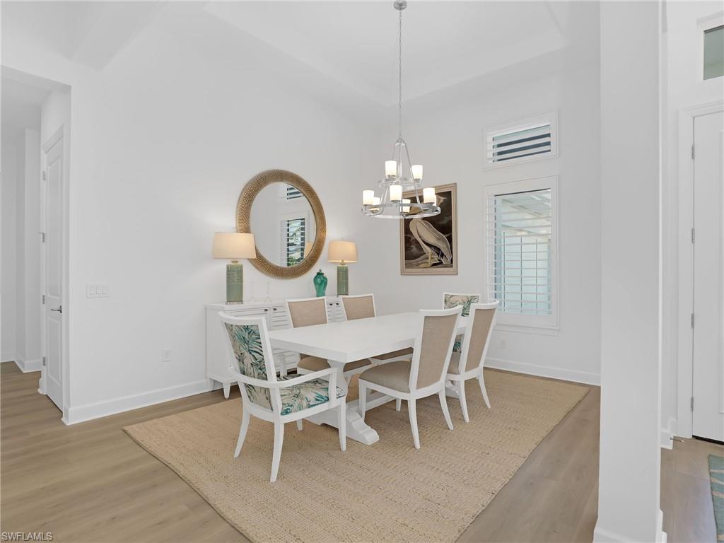 15432 Turin Drive Naples, FL 34114 - Photo 5 of 45 a view of a dining room with furniture and chandelier