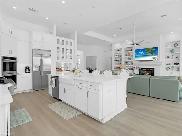 a kitchen with stainless steel appliances kitchen island granite countertop a sink and cabinets