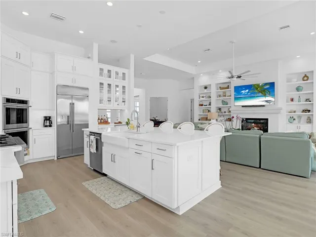 a kitchen with stainless steel appliances kitchen island granite countertop a sink and cabinets