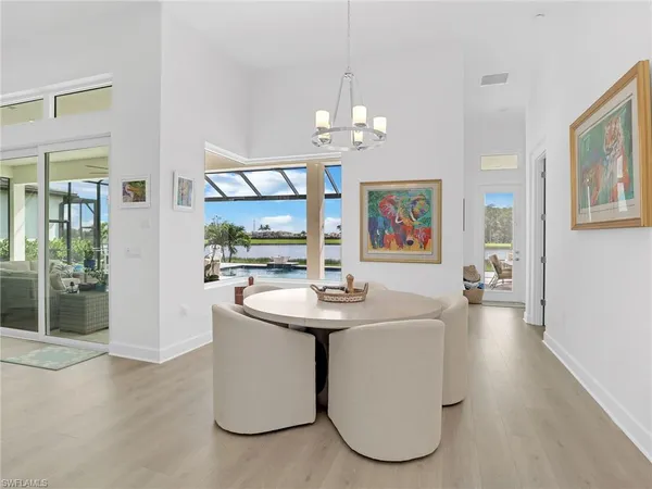 a living room with furniture a chandelier and a window