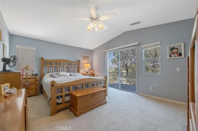 a spacious bedroom with a bed and a large window
