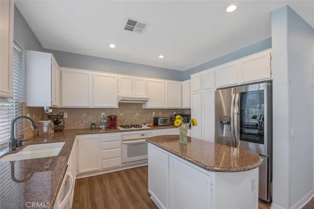 a kitchen with a sink stove and refrigerator