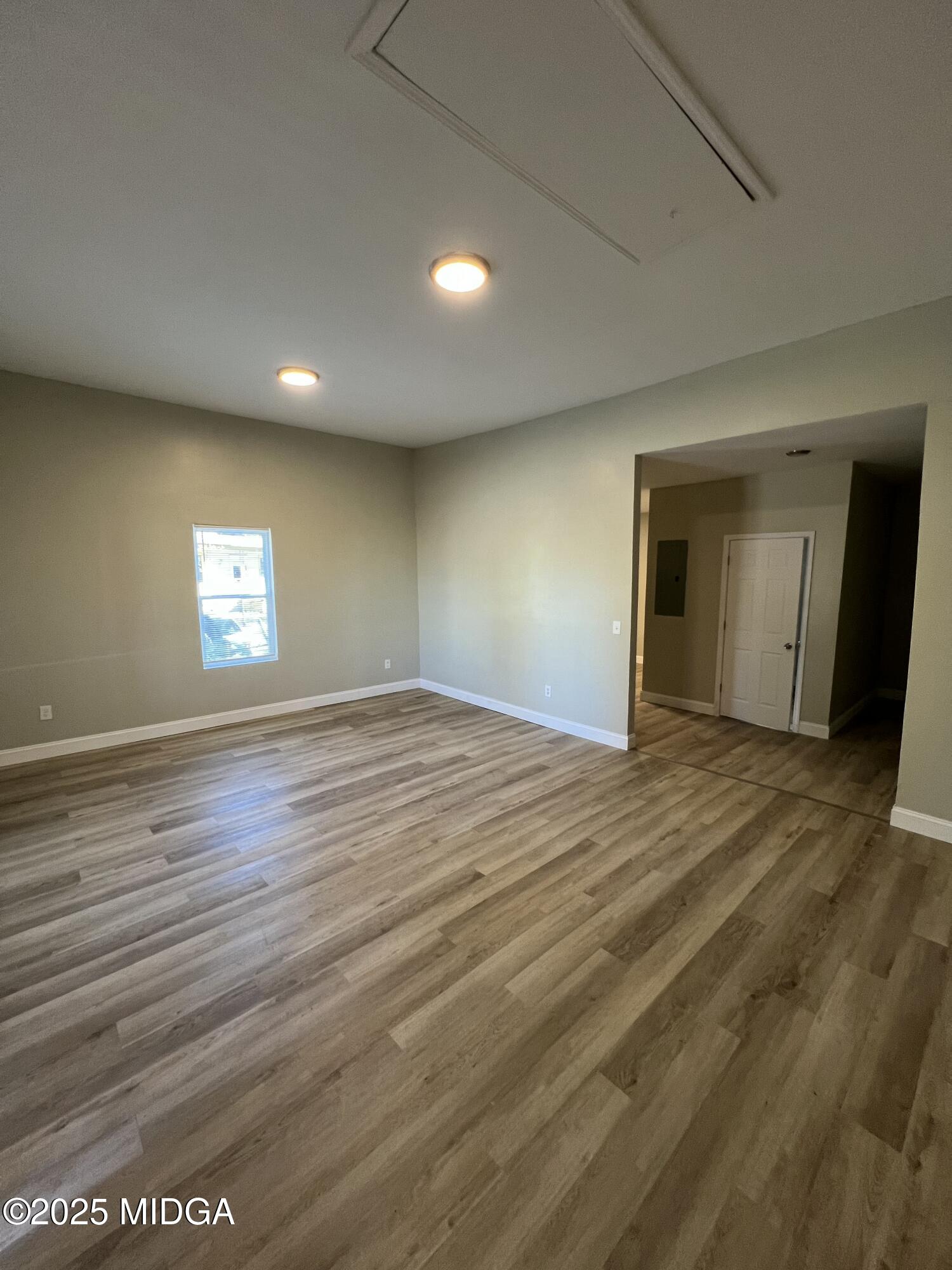 974 Tenney Avenue Macon, GA 31201 - Photo 5 of 6 an empty room with wooden floor and window