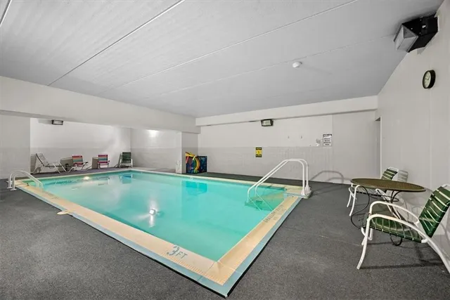 a room with furniture pool and windows