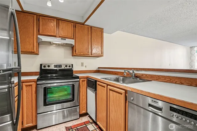 a kitchen that has a sink and a refrigerator