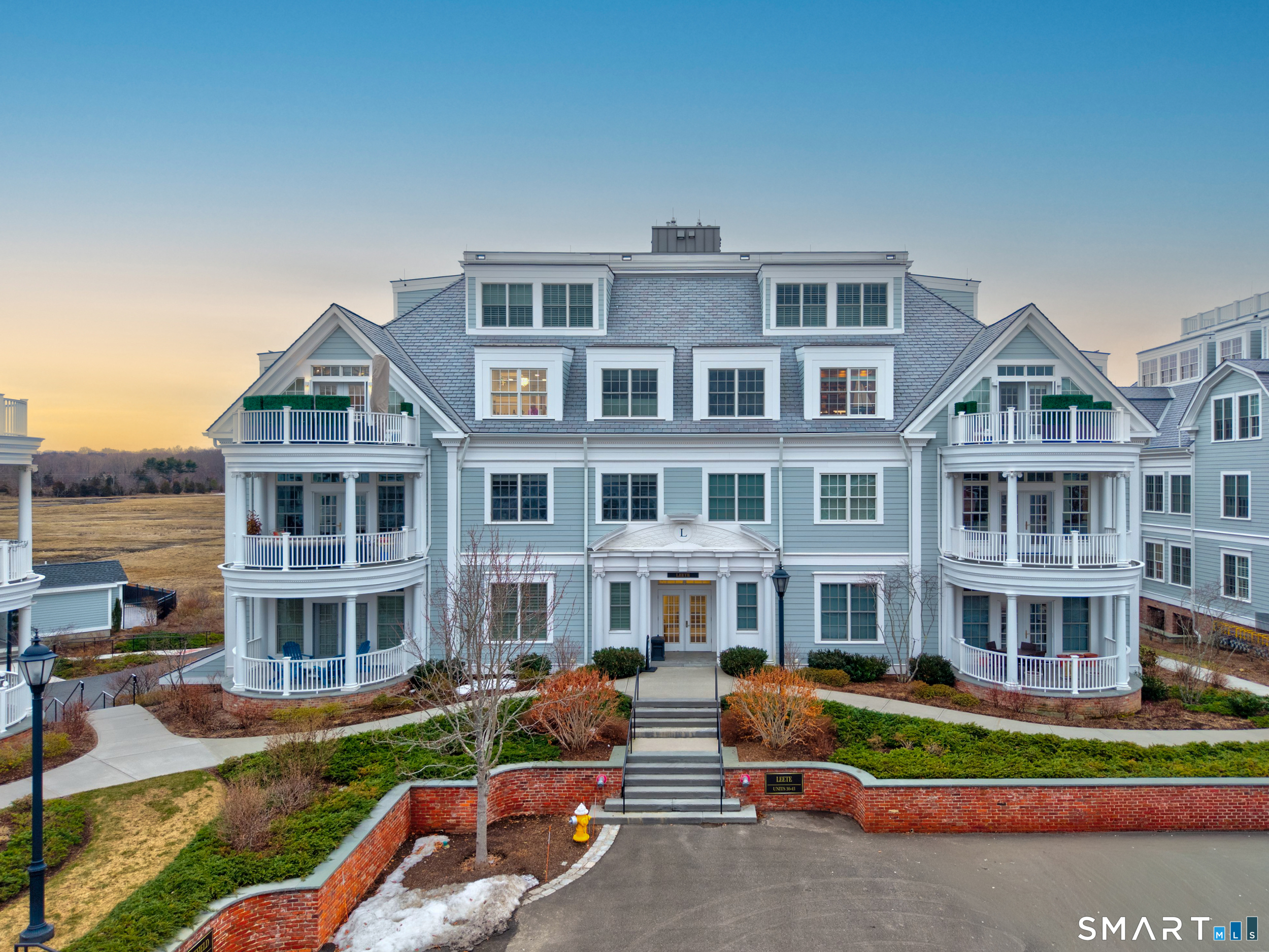 66 High Street, Unit 38 Guilford, CT 06437 - Photo 1 of 40 a front view of residential houses with yard and green space