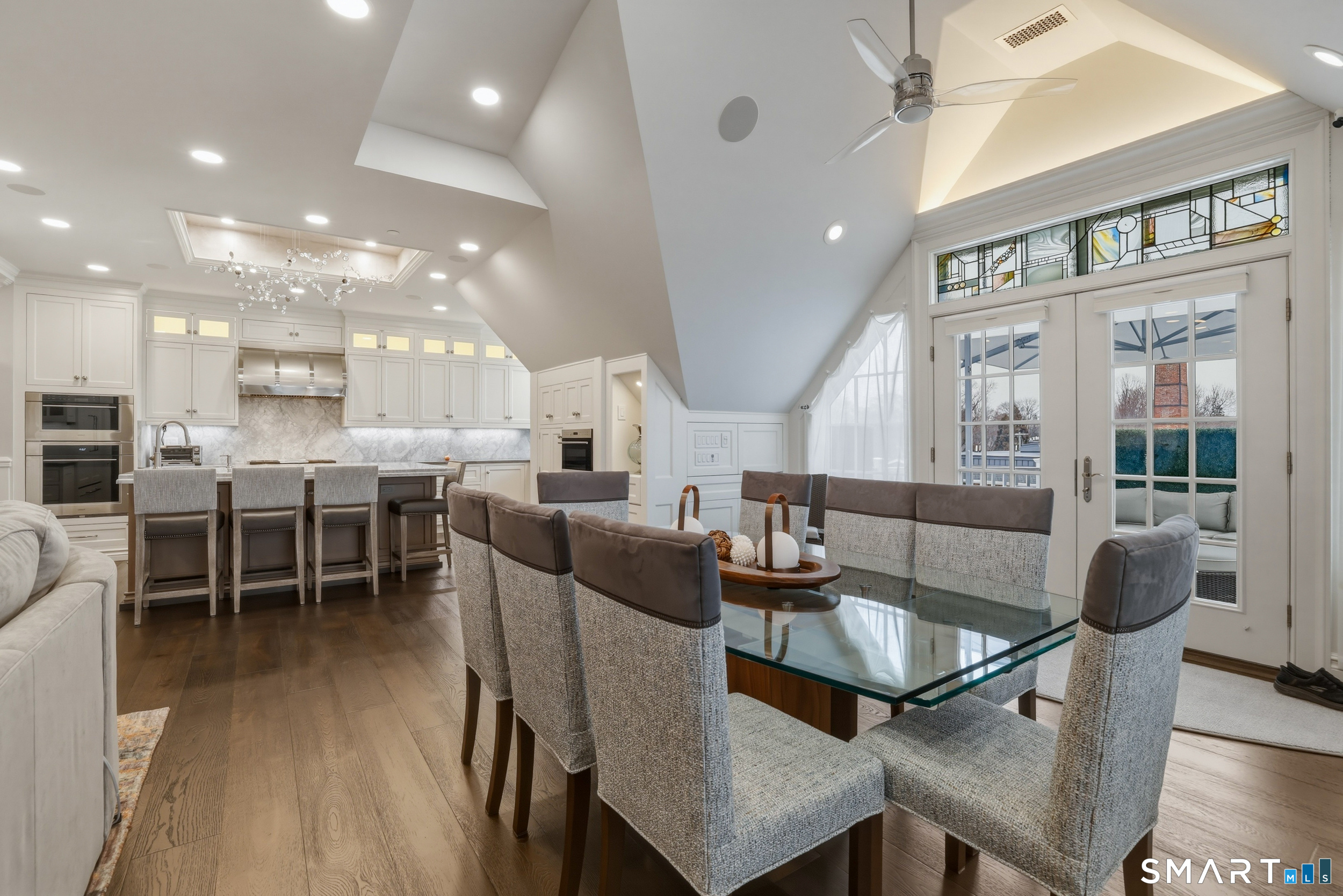 66 High Street, Unit 38 Guilford, CT 06437 - Photo 14 of 40 a dining room with furniture a kitchen view and a chandelier