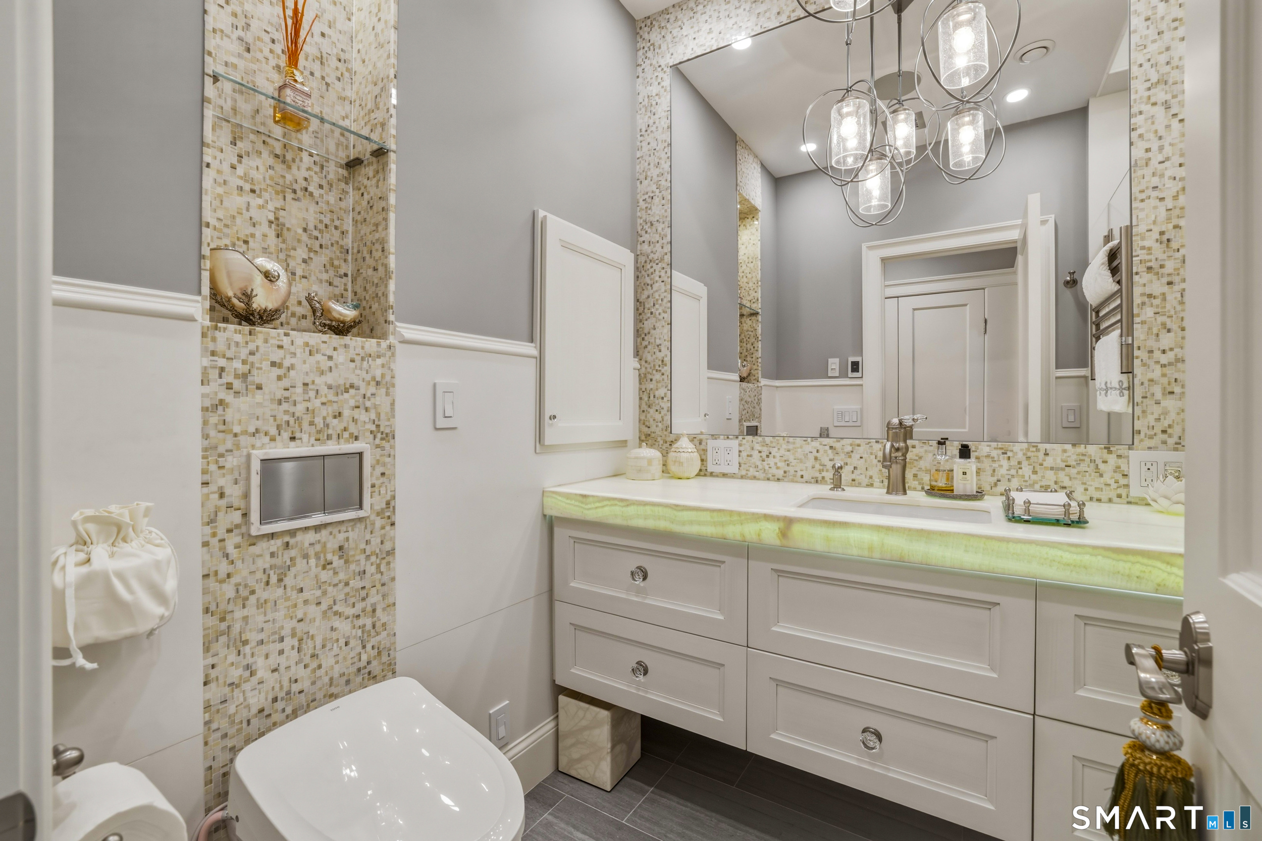 66 High Street, Unit 38 Guilford, CT 06437 - Photo 17 of 40 a bathroom with a toilet a sink and mirror