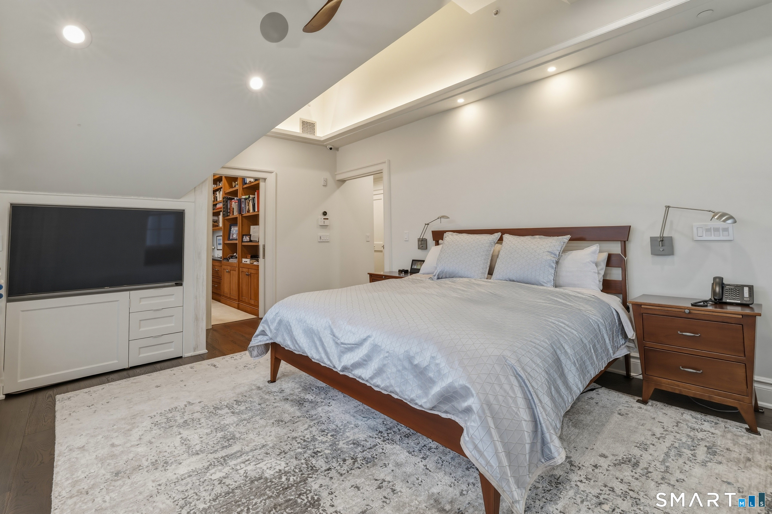 66 High Street, Unit 38 Guilford, CT 06437 - Photo 19 of 40 a bedroom with a large bed and a flat tv screen on dresser