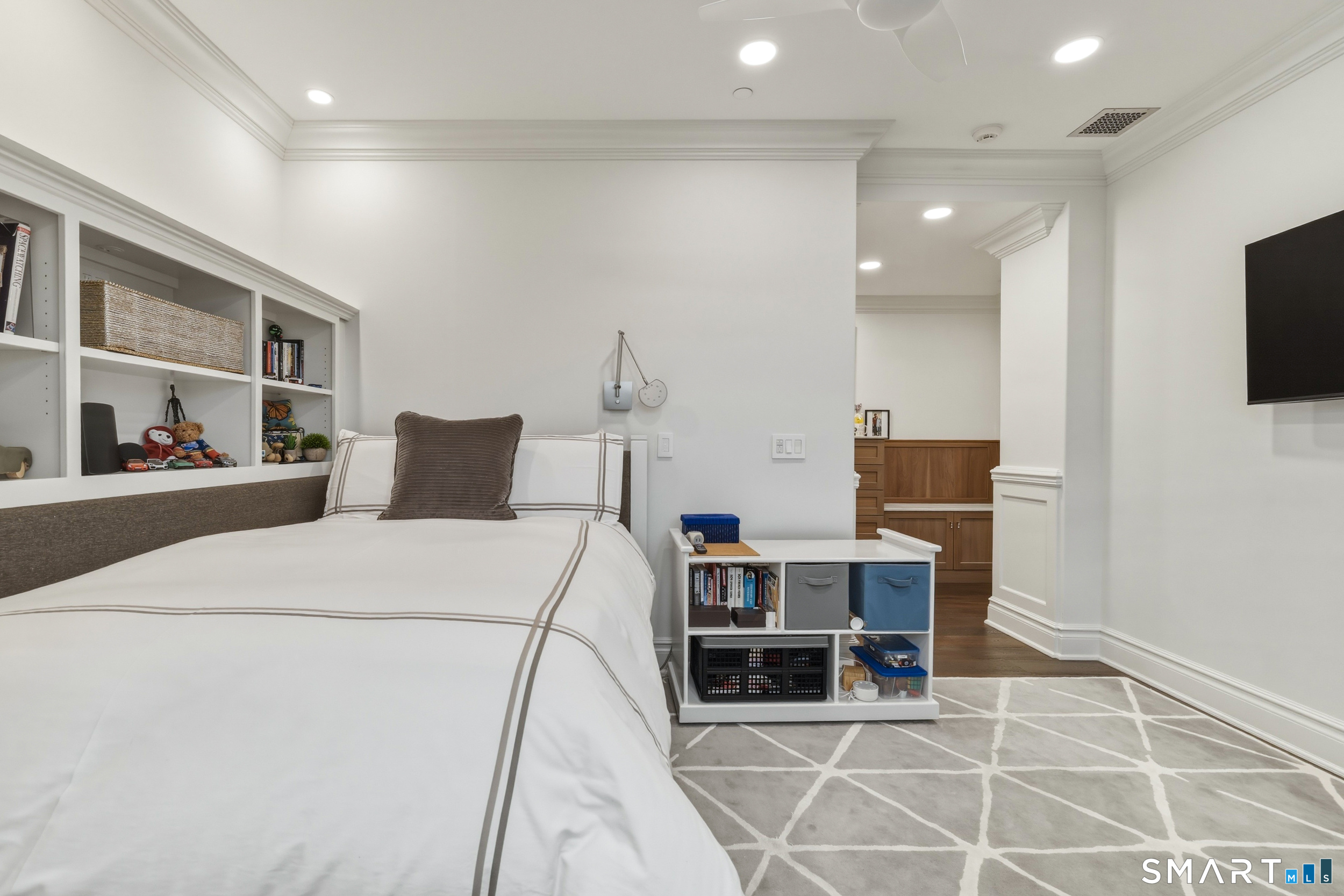 66 High Street, Unit 38 Guilford, CT 06437 - Photo 24 of 40 a bedroom with a bed and flat screen tv