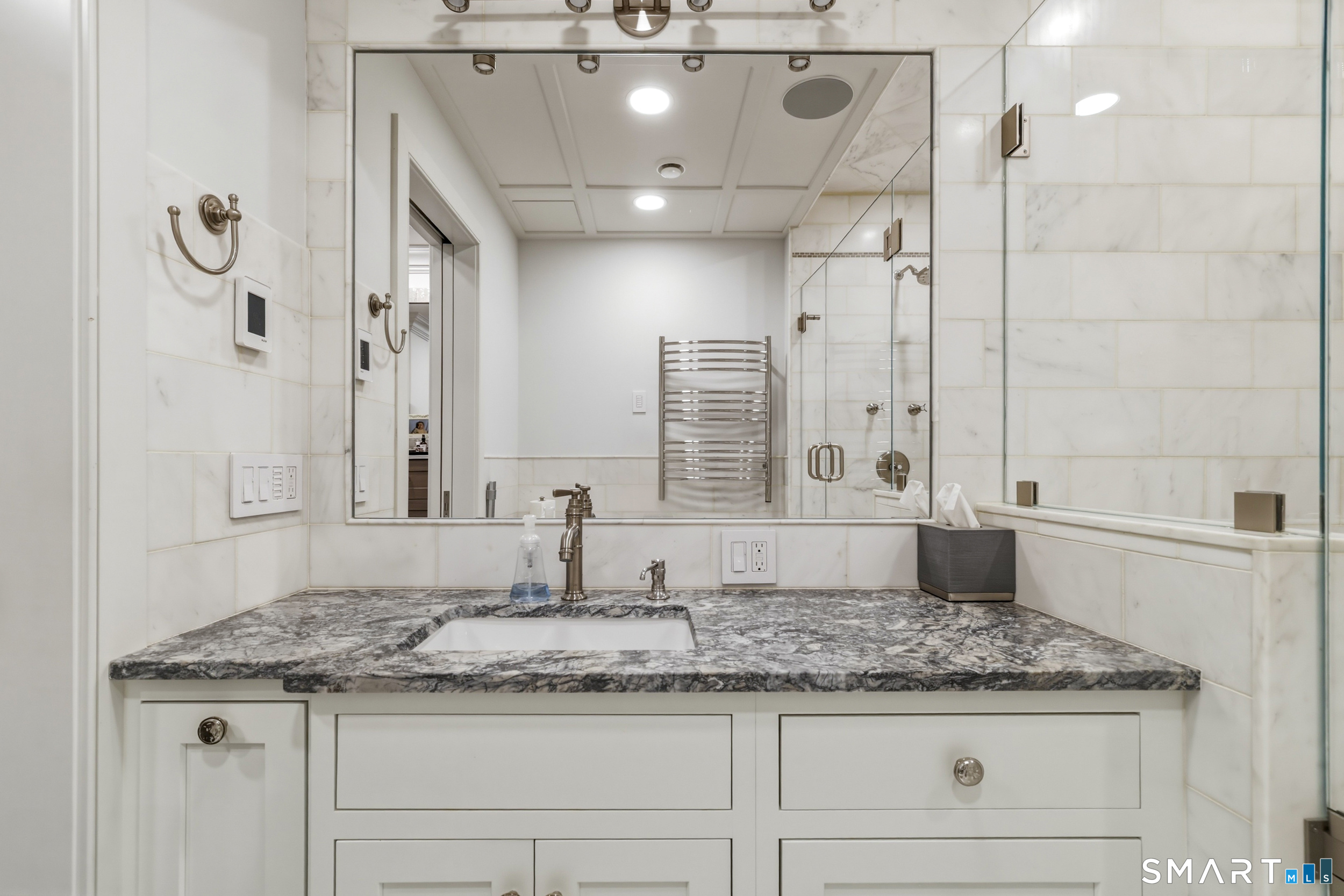 66 High Street, Unit 38 Guilford, CT 06437 - Photo 27 of 40 a bathroom with a granite countertop sink a mirror and shower