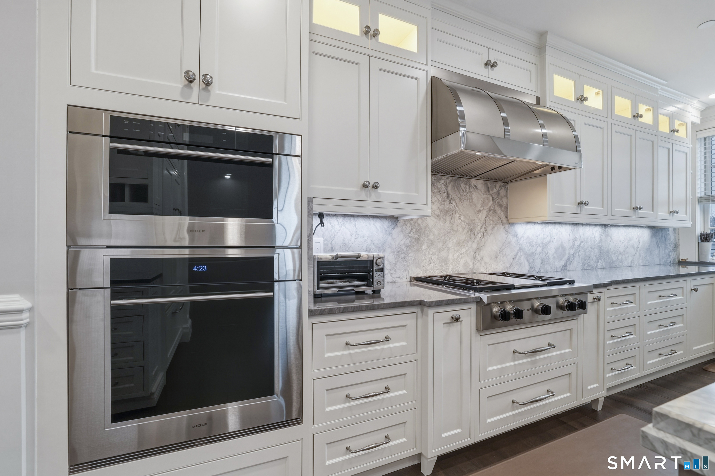 66 High Street, Unit 38 Guilford, CT 06437 - Photo 7 of 40 a kitchen with stainless steel appliances granite countertop white cabinets and a stove