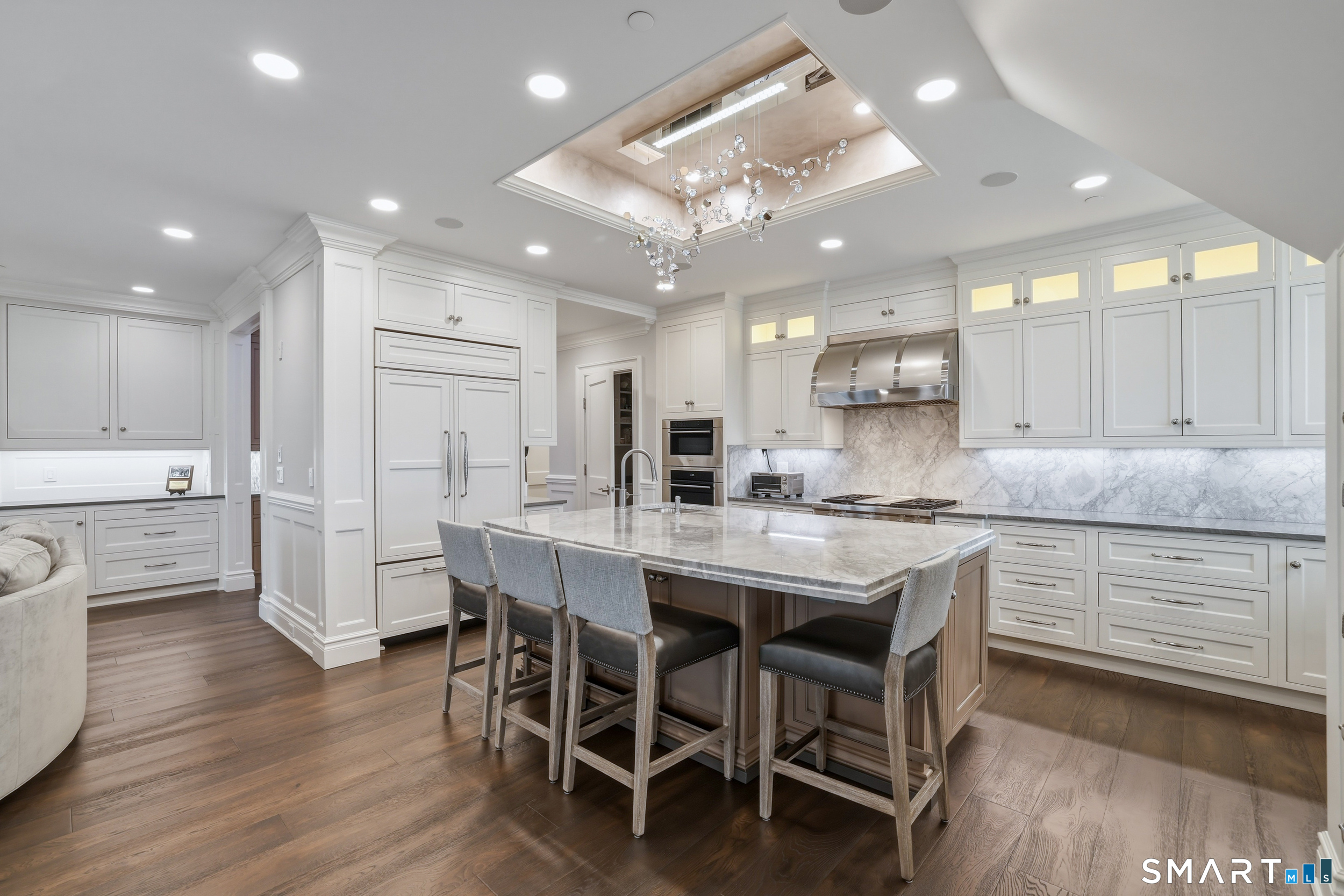66 High Street, Unit 38 Guilford, CT 06437 - Photo 8 of 40 a kitchen with stainless steel appliances kitchen island granite countertop a table chairs sink and cabinets