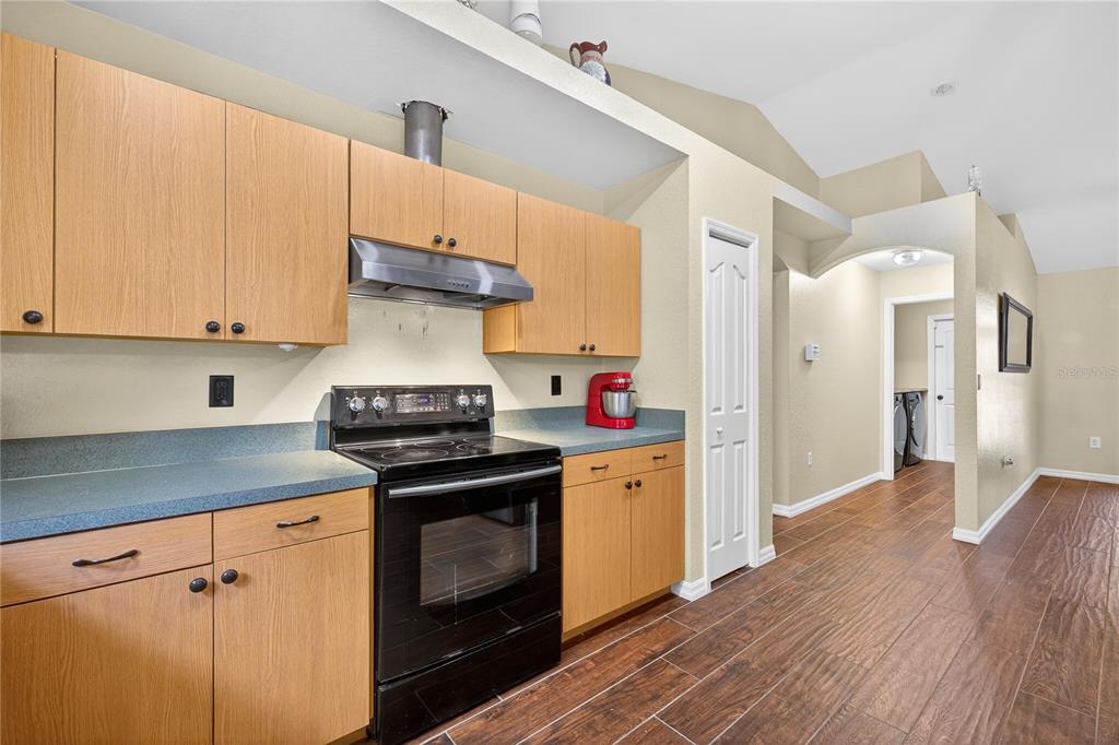 1429 Laredo Avenue Spring Hill, FL 34608 - Photo 12 of 28 a kitchen with granite countertop a stove and a wooden floors