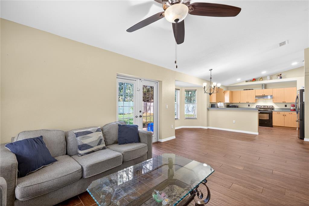 1429 Laredo Avenue Spring Hill, FL 34608 - Photo 13 of 28 a living room with furniture and kitchen view