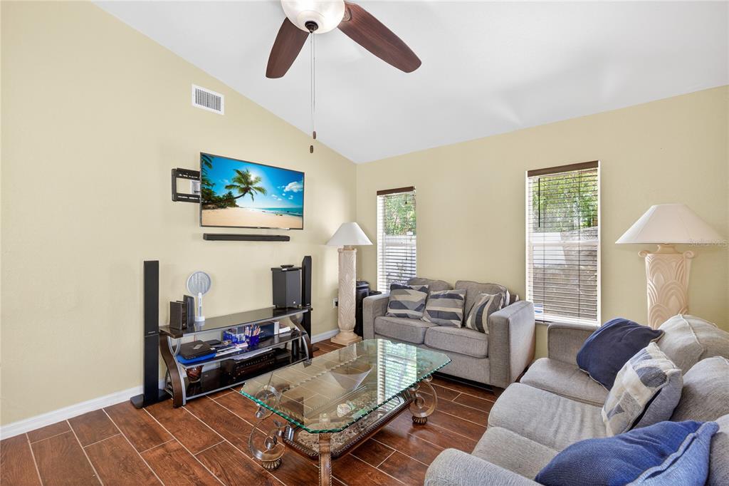 1429 Laredo Avenue Spring Hill, FL 34608 - Photo 14 of 28 a living room with furniture a rug and a flat screen tv