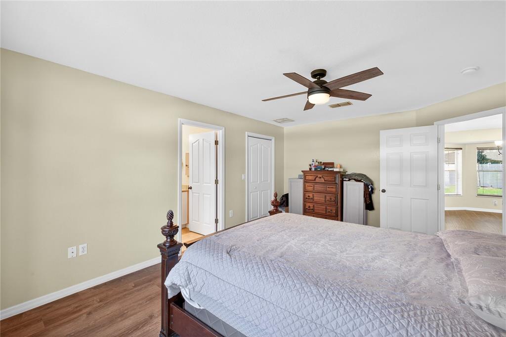 1429 Laredo Avenue Spring Hill, FL 34608 - Photo 16 of 28 a bedroom with a bed and a chandelier
