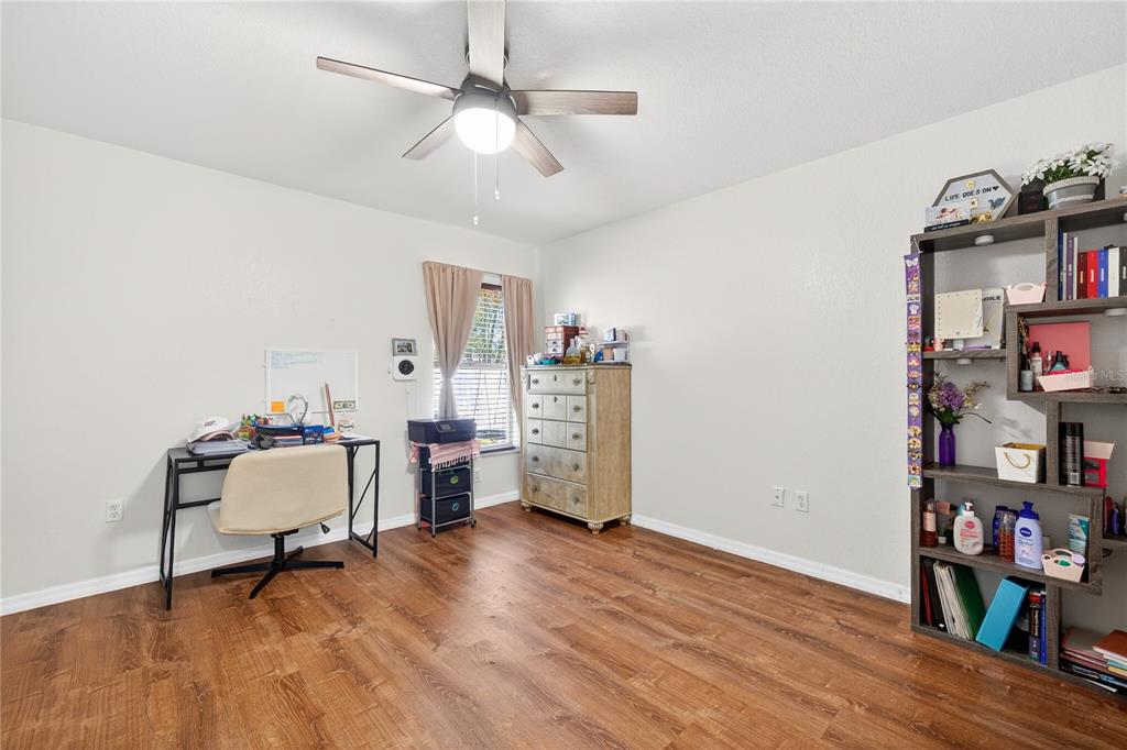 1429 Laredo Avenue Spring Hill, FL 34608 - Photo 19 of 28 a view of a workspace with furniture and wooden floor