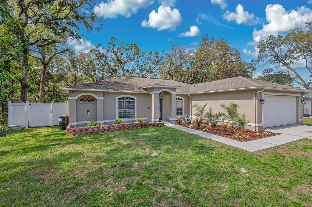 1429 Laredo Avenue Spring Hill, FL 34608 - Photo 2 of 28 a view of a house with backyard sitting area and garden