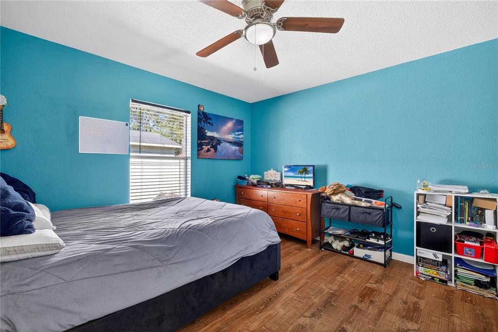 1429 Laredo Avenue Spring Hill, FL 34608 - Photo 21 of 28 a bedroom with a bed and a book shelf