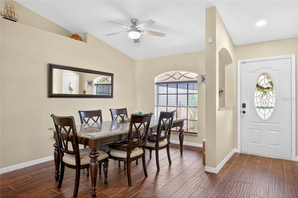 1429 Laredo Avenue Spring Hill, FL 34608 - Photo 3 of 28 a view of a dining room with furniture window and wooden floor