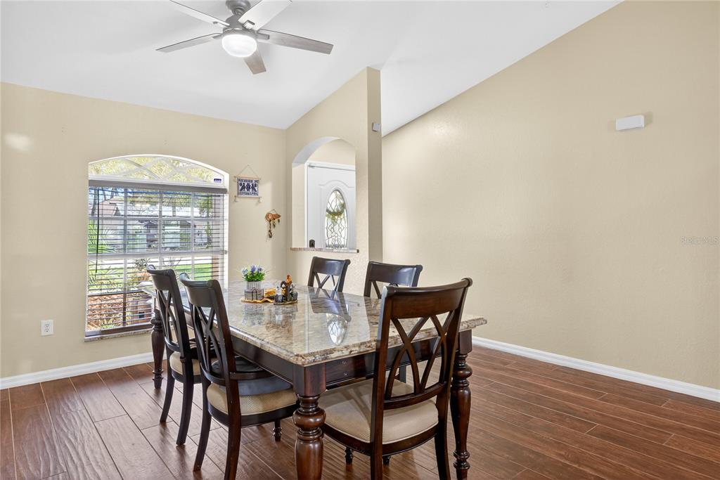 1429 Laredo Avenue Spring Hill, FL 34608 - Photo 4 of 28 a view of a dining room with furniture window and wooden floor
