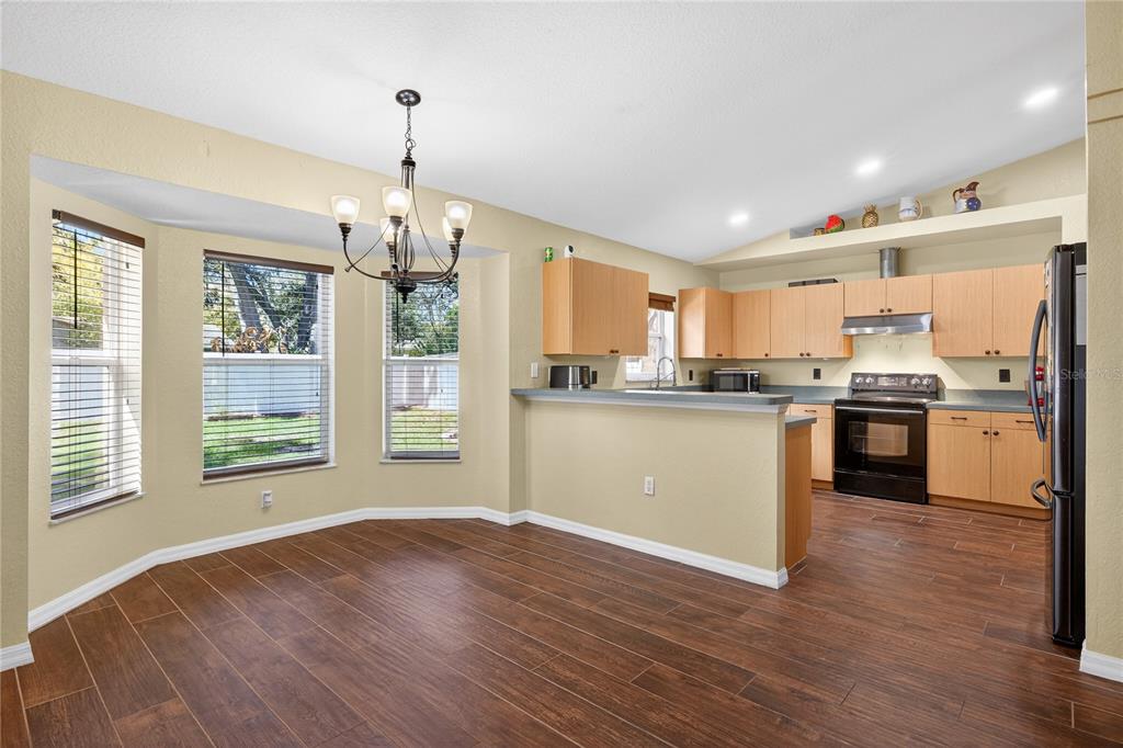 1429 Laredo Avenue Spring Hill, FL 34608 - Photo 7 of 28 a view of a kitchen with granite countertop stainless steel appliances and a large window