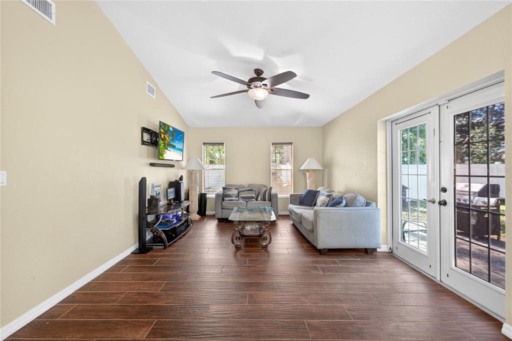1429 Laredo Avenue Spring Hill, FL 34608 - Photo 8 of 28 a living room with fireplace furniture and a wooden floor
