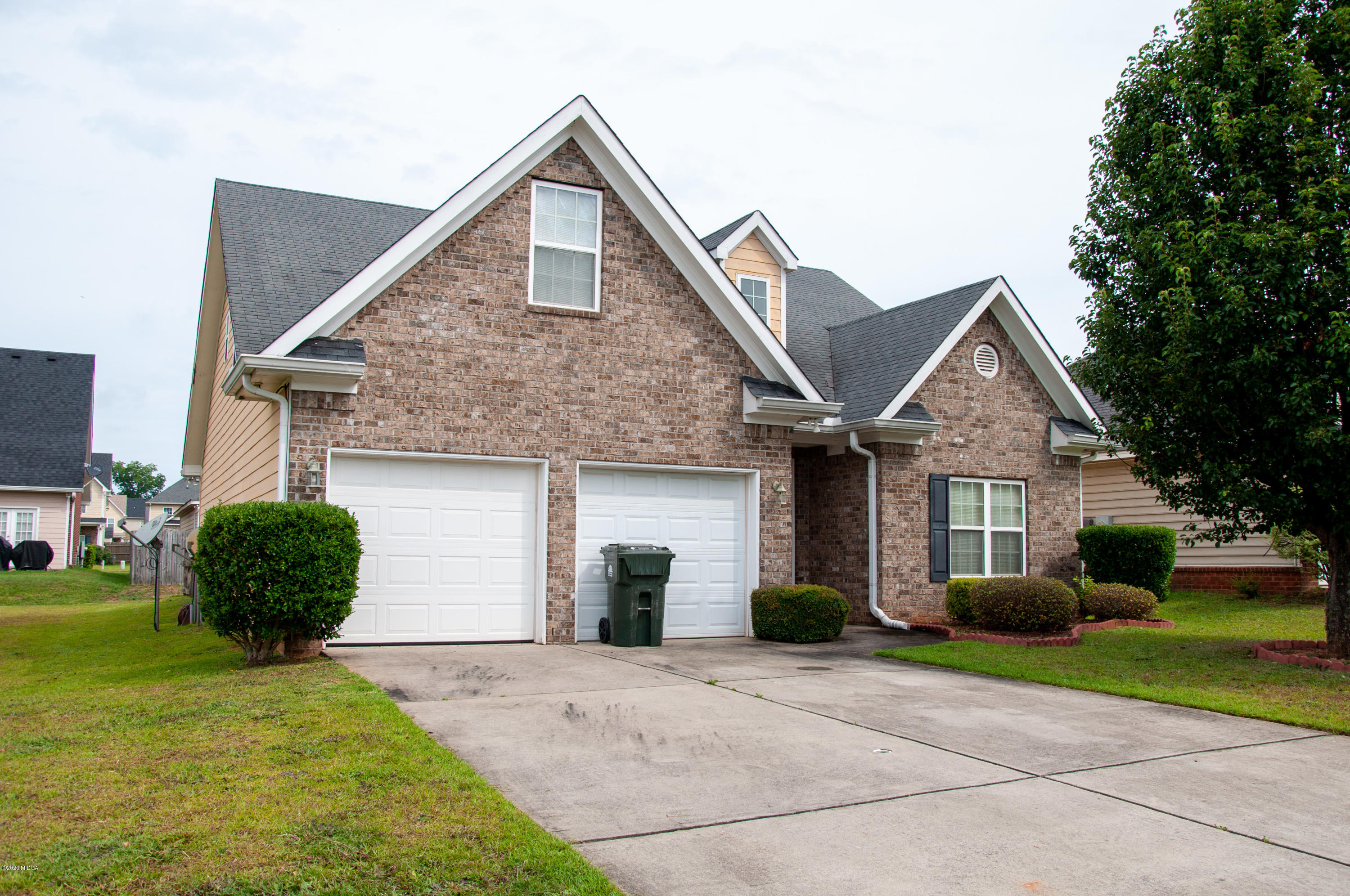 480 Bob White Road Macon, GA 31216 - Photo 2 of 28 a front view of a house with a yard and garage