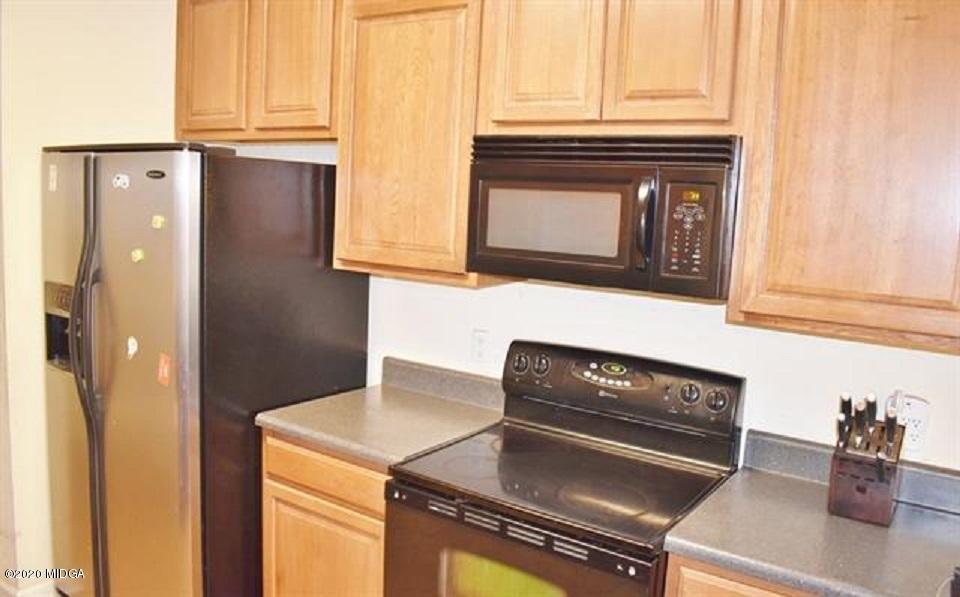 480 Bob White Road Macon, GA 31216 - Photo 16 of 28 a kitchen with granite countertop cabinets and black appliances