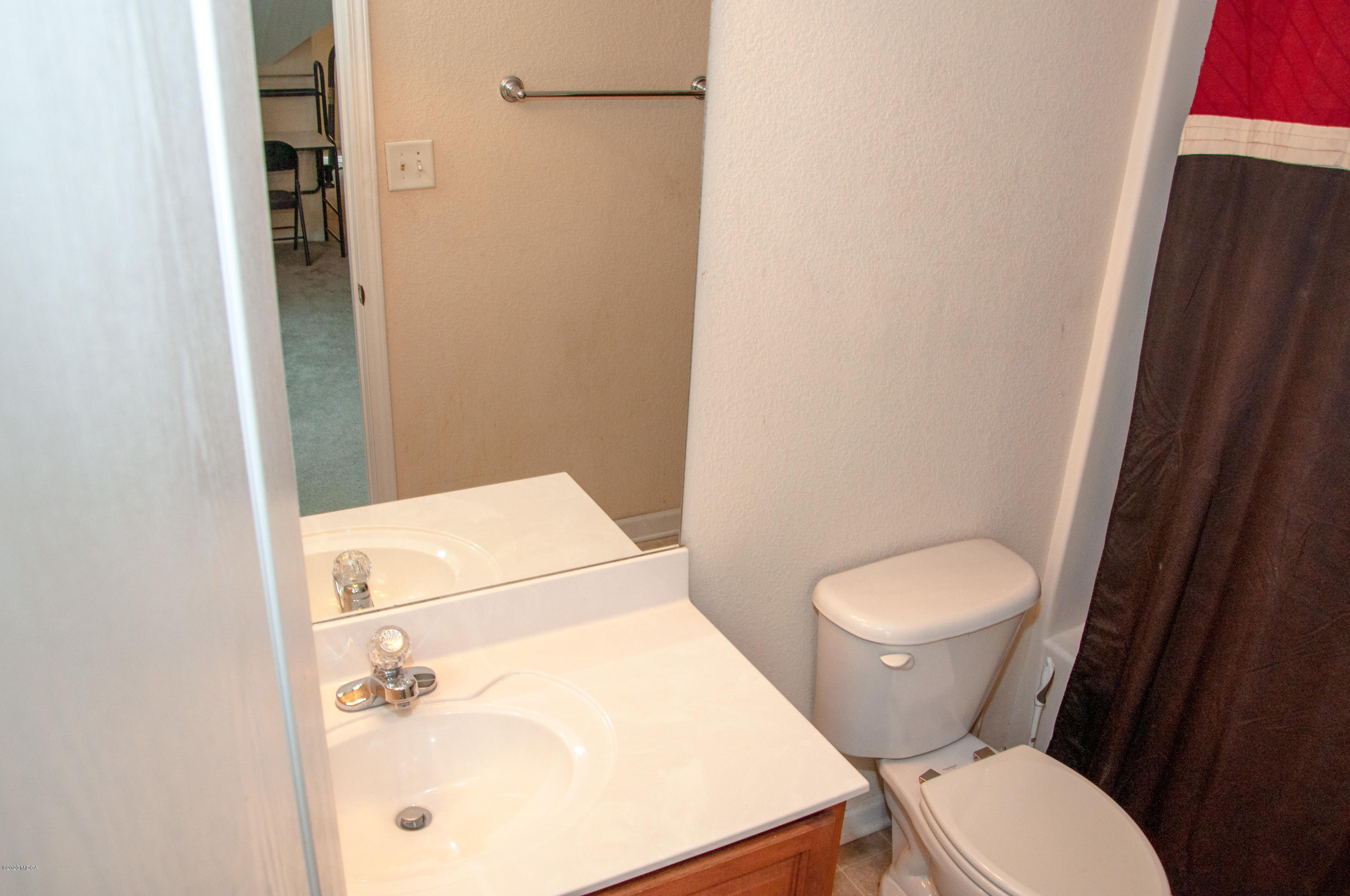 480 Bob White Road Macon, GA 31216 - Photo 25 of 28 a white toilet sitting next to a bathroom sink