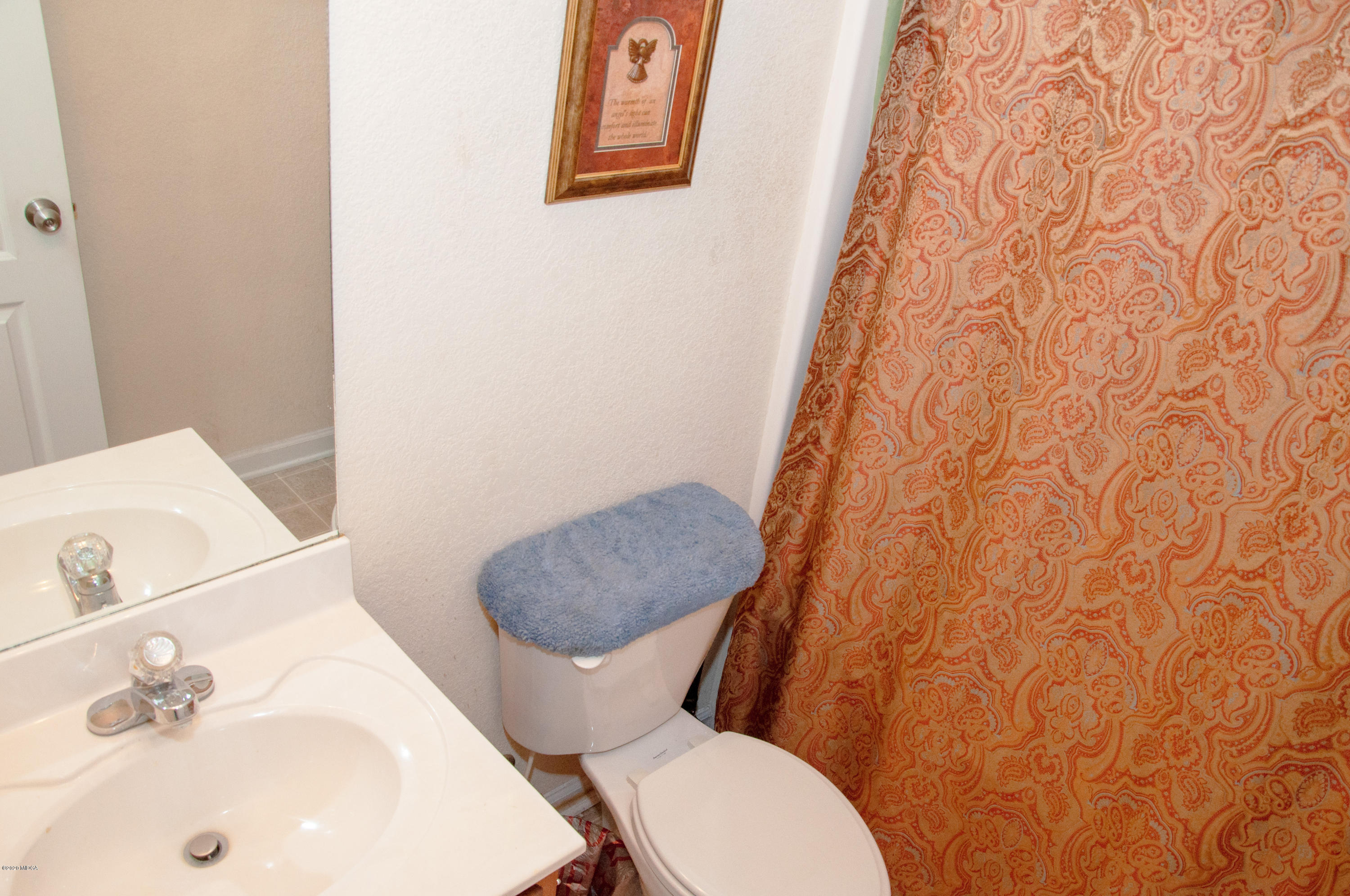 480 Bob White Road Macon, GA 31216 - Photo 6 of 28 a white toilet sitting next to a bathroom sink