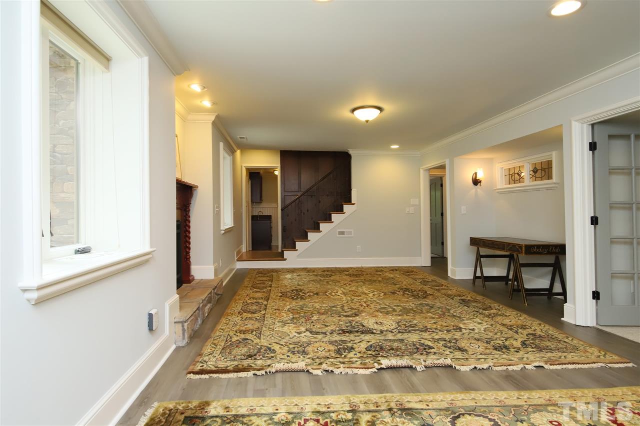 3411 Dover Road Durham, NC 27707 - Photo 18 of 29 The stairs open up onto a large family room with gas fireplace.