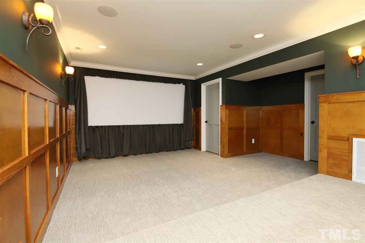 3411 Dover Road Durham, NC 27707 - Photo 20 of 29 A multilevel paneled theatre room provides a place to enjoy large screen viewing with the projection TV set up. Just off the theatre room are two storage areas plus the unfinished mechanical room.