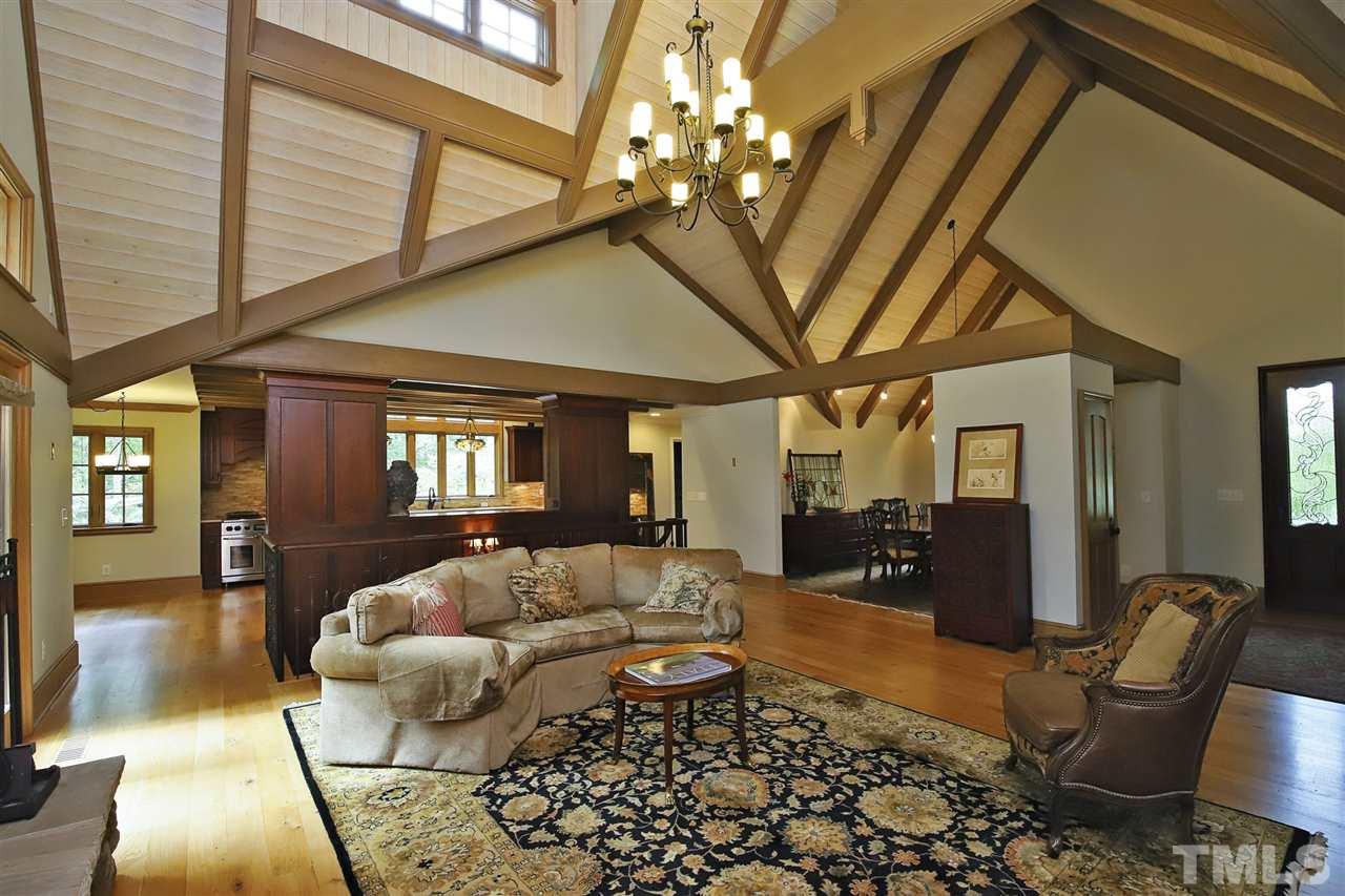 3411 Dover Road Durham, NC 27707 - Photo 8 of 29 Cathedral ceilings, beams, and a chandelier all combine to establish the personality of the home.From the living room, there are views out back, to the foyer, to the dining room, to the kitchen and of the open stairs to the lower level.