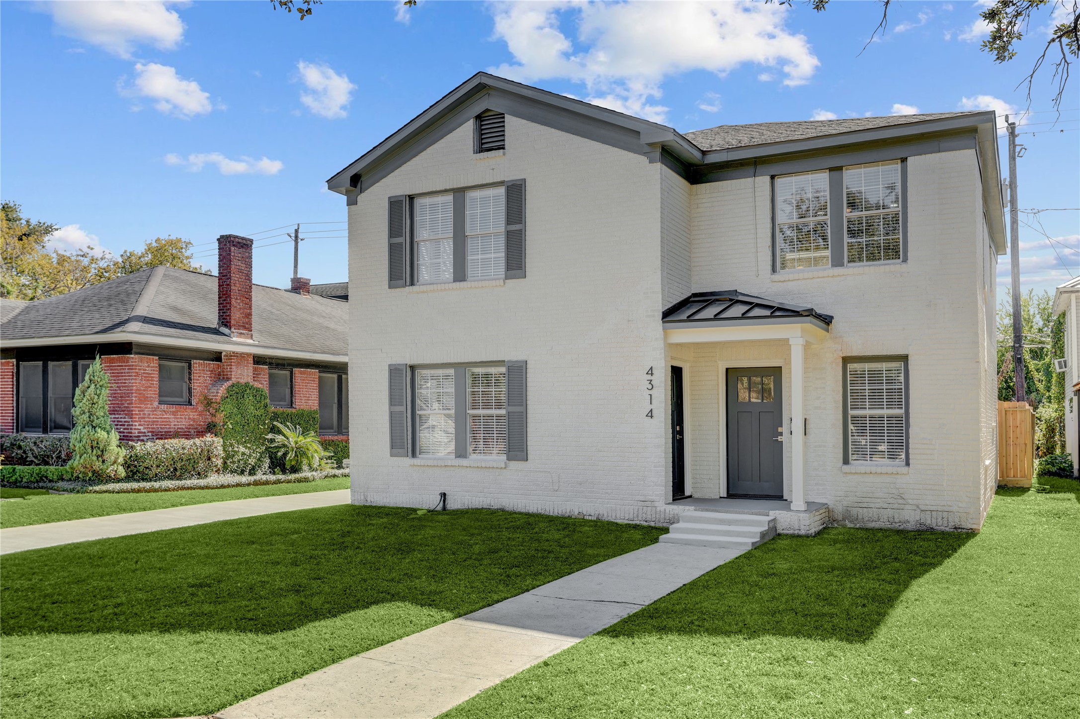 4314 Bell Street, Unit 1 Houston, TX 77023 - Photo 1 of 17 a front view of a house with a yard and garage