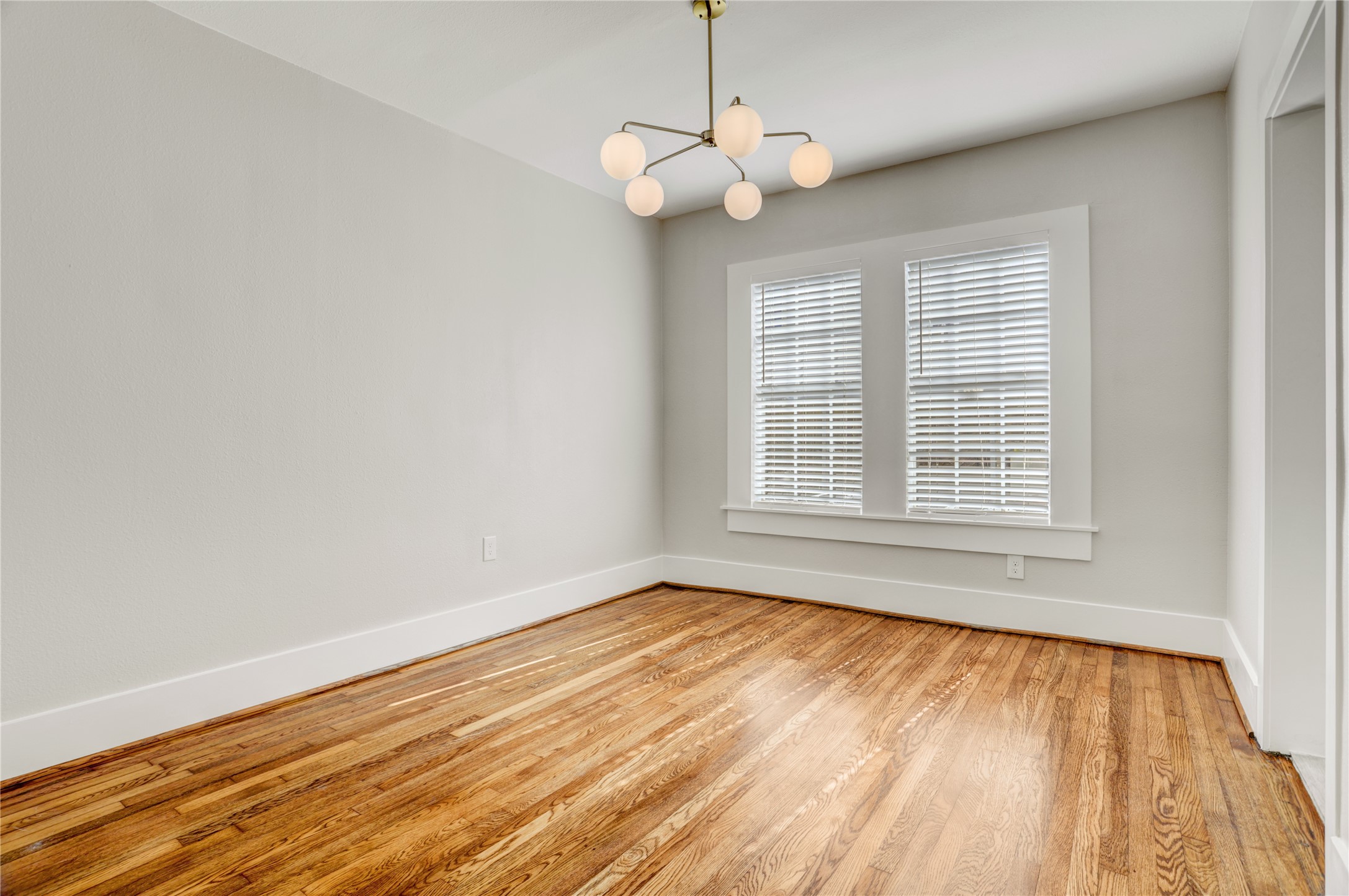 4314 Bell Street, Unit 1 Houston, TX 77023 - Photo 12 of 17 a view of an empty room with wooden floor and a window