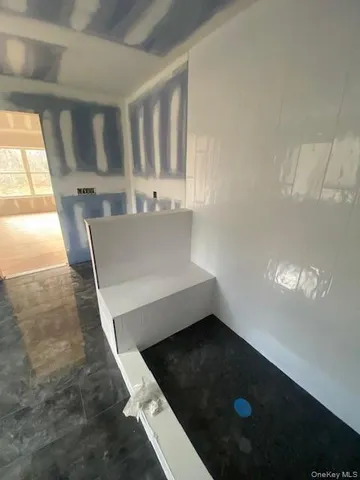 a view of a field with trees in the background