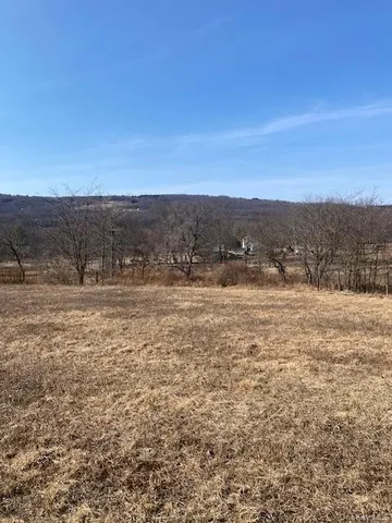 a view of basketball court with trees in background