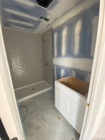 a bathroom with a tub a sink and a shower