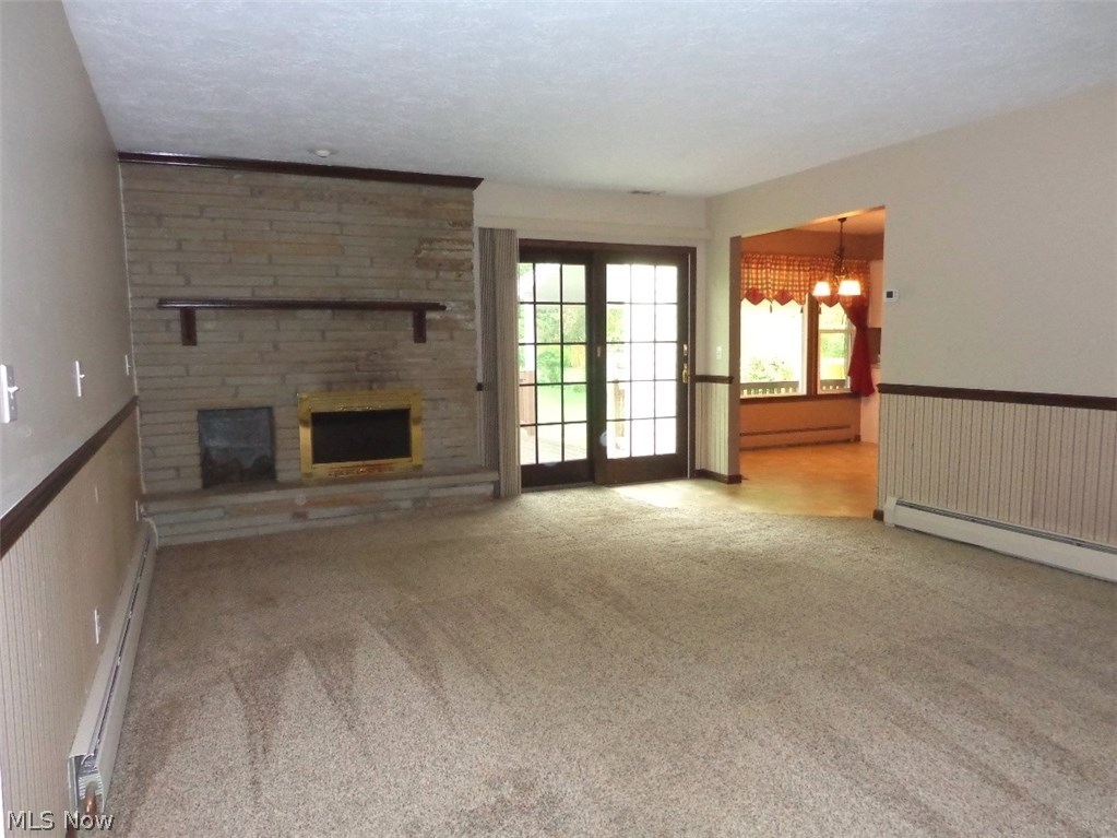 11167 Robson Road Grafton, OH 44044 - Photo 14 of 33 Another view of the Family room accented with the woodburner fireplace and the sliding door that leads out to the rear deck.
