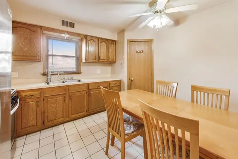 a kitchen with a sink cabinets and window
