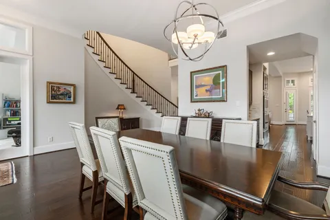 a view of a dining room with furniture wooden floor and chandelier