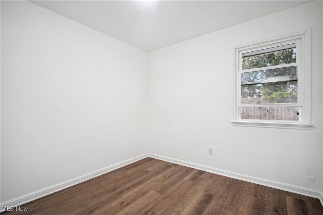 8796 West Ridgewood Drive Cleveland, OH 44130 - Photo 30 of 38 Empty room with dark hardwood / wood-style flooring