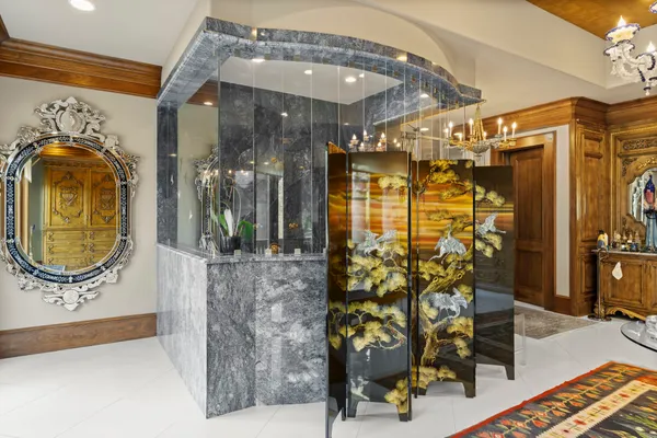 a living room with furniture a flat screen tv and a floor to ceiling window