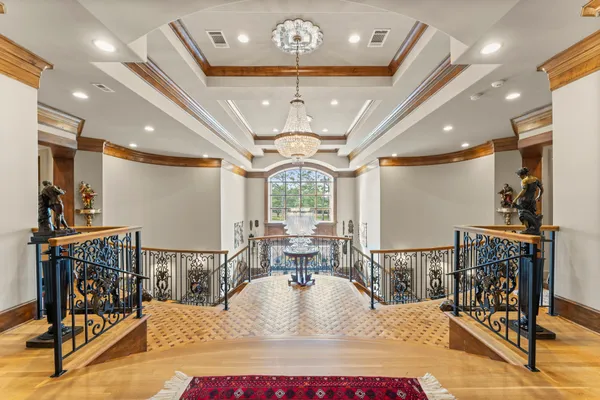 a living room with furniture a fireplace and large windows