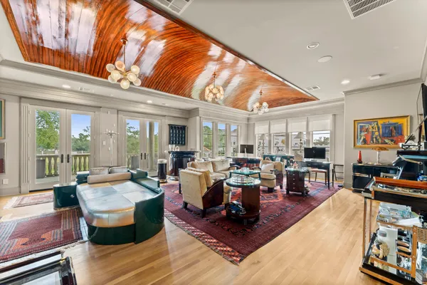 a living room with furniture and a chandelier