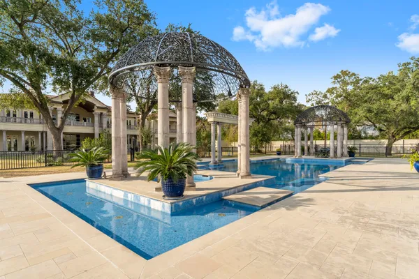 a view of a swimming pool with outdoor seating