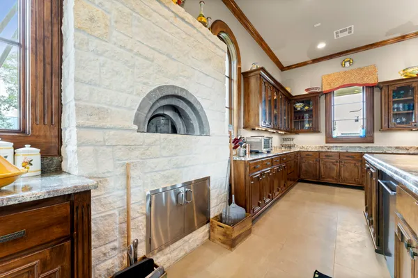 a kitchen with stainless steel appliances granite countertop a sink a counter top space and living room view