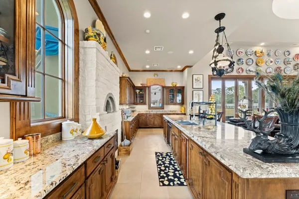 a room with lots of tables a large window and chairs